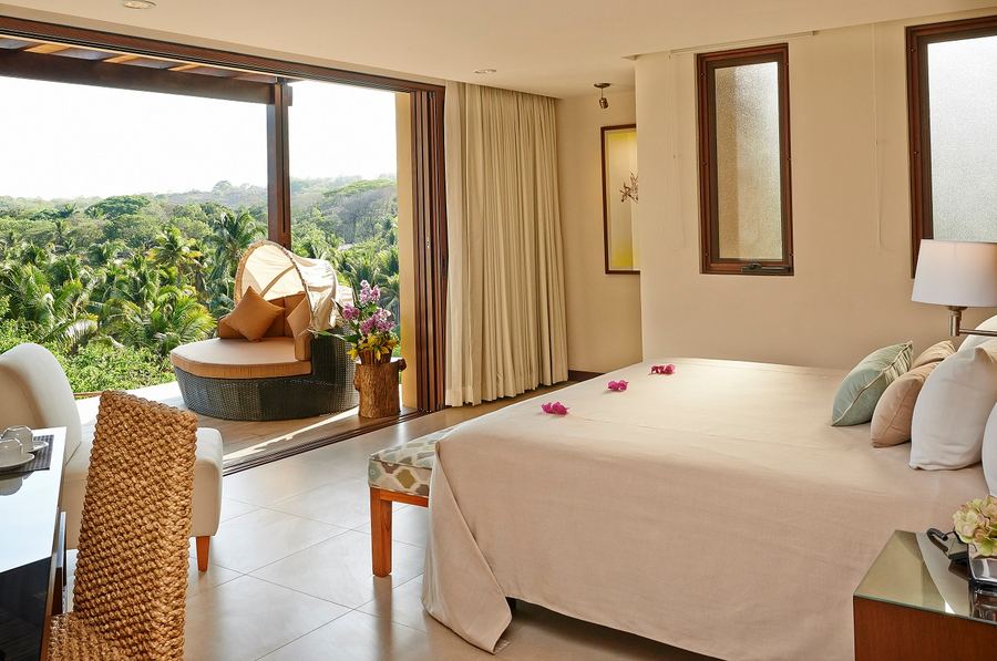 Suite terrace overlooking the tropical garden at Las Flores Resort