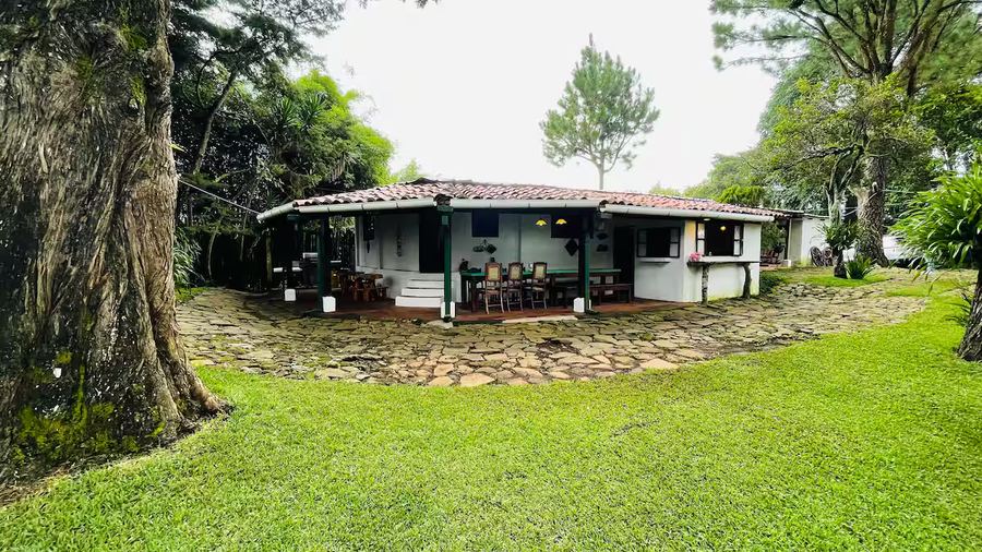 Main cabin exterior at Monte Berat framed by lawn and gardens