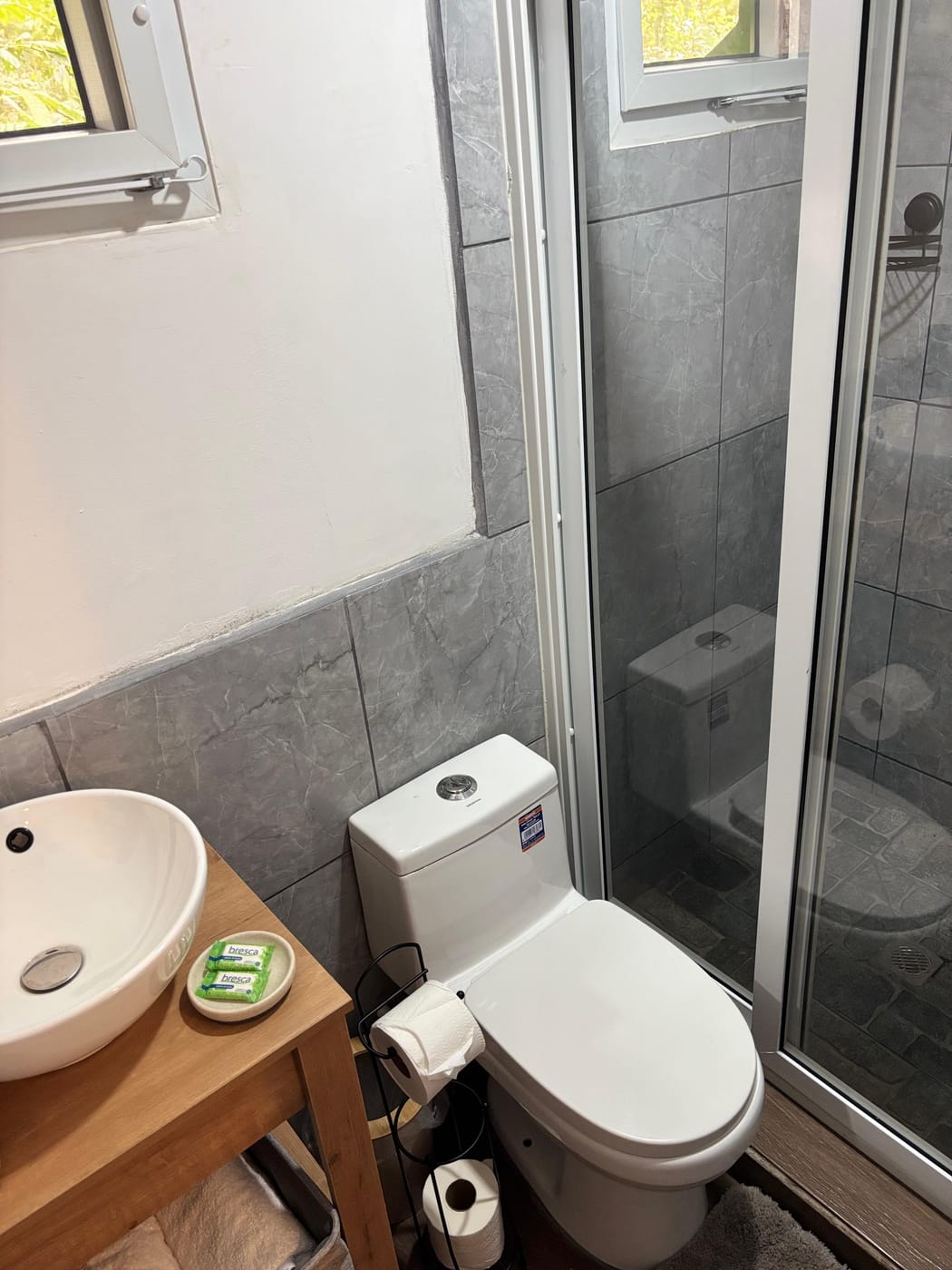Private bathroom and glass shower inside an Umbra cabin