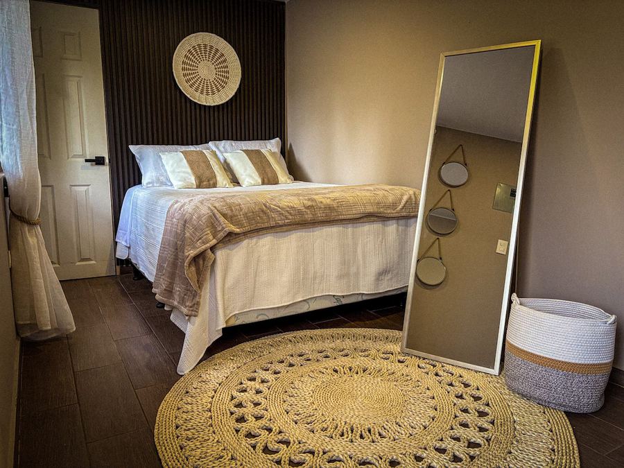 Umbra cabin bedroom with round mirror at Monte Berat